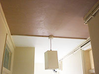 The Earlsfield plasterer plastering a hallway ceiling in SW18 folowing water damage