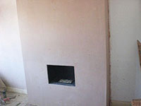 The Raynes Park Plasterer plastering a lounge fireplace in SW20